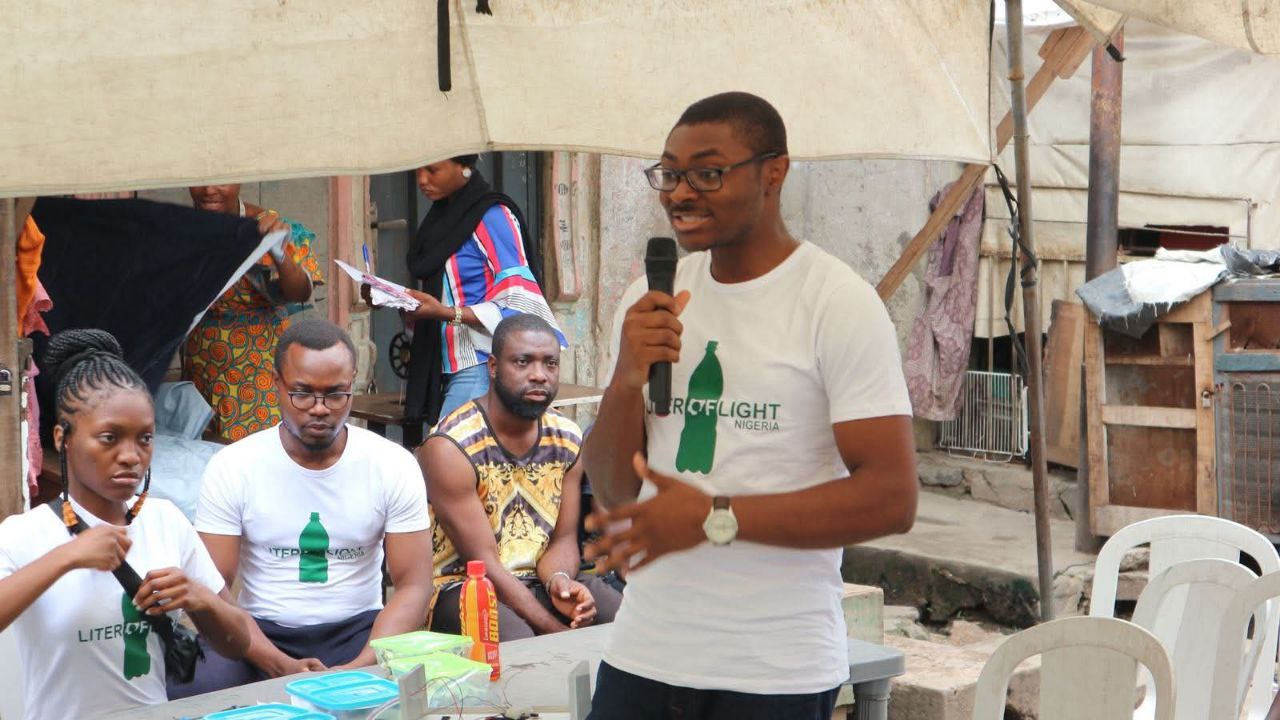 Dr Adaji with community members at Litre of Light Nigeria