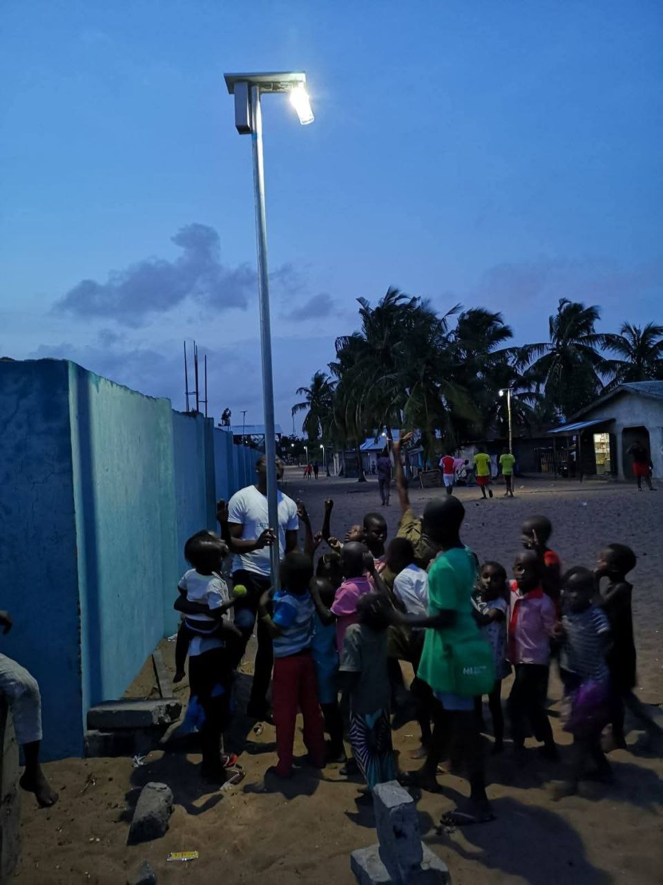 Children gathered around a new solar street light, Litre of Light Nigeria